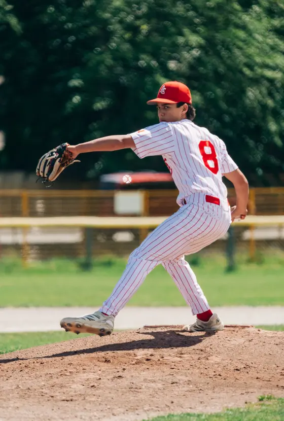 A Cardinals pitcher mid-windup during a game.